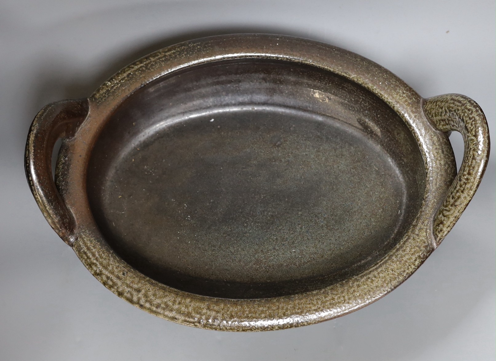 A large studio pottery grey salt glazed stoneware two handled dish, unmarked, 36cm wide